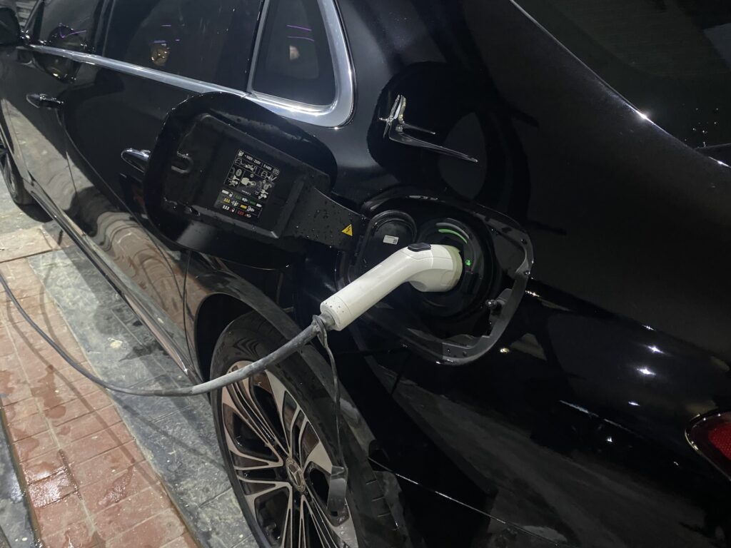 Charging cable connected to an electric vehicle in Abuja