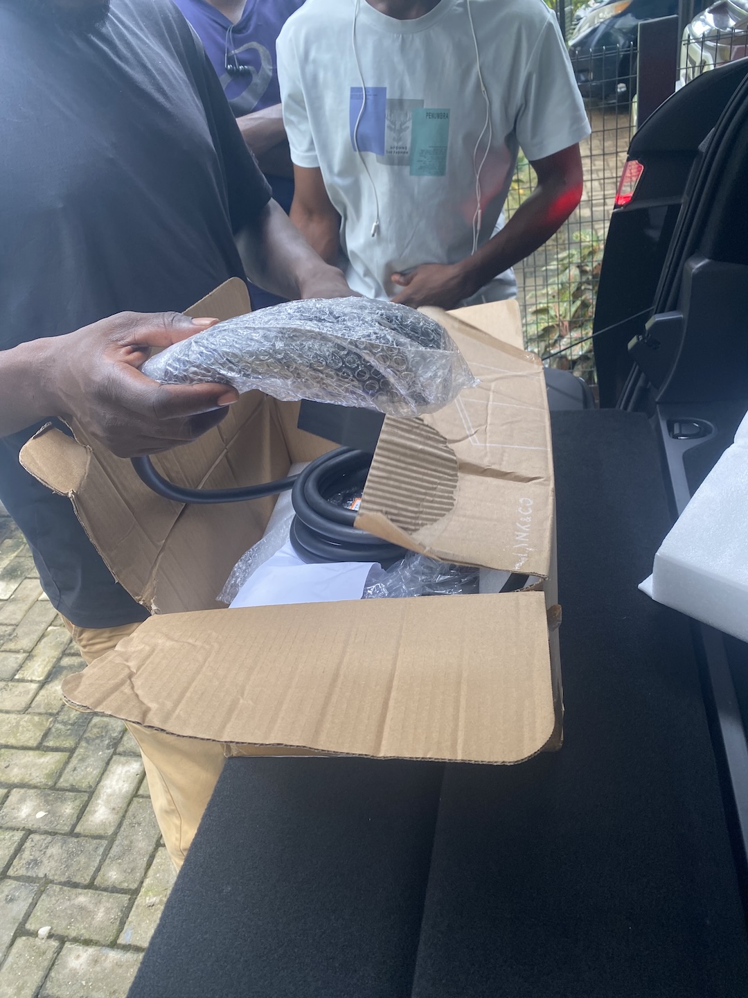 PlugPoint EV Abuja installers preparing an EV charger for installation