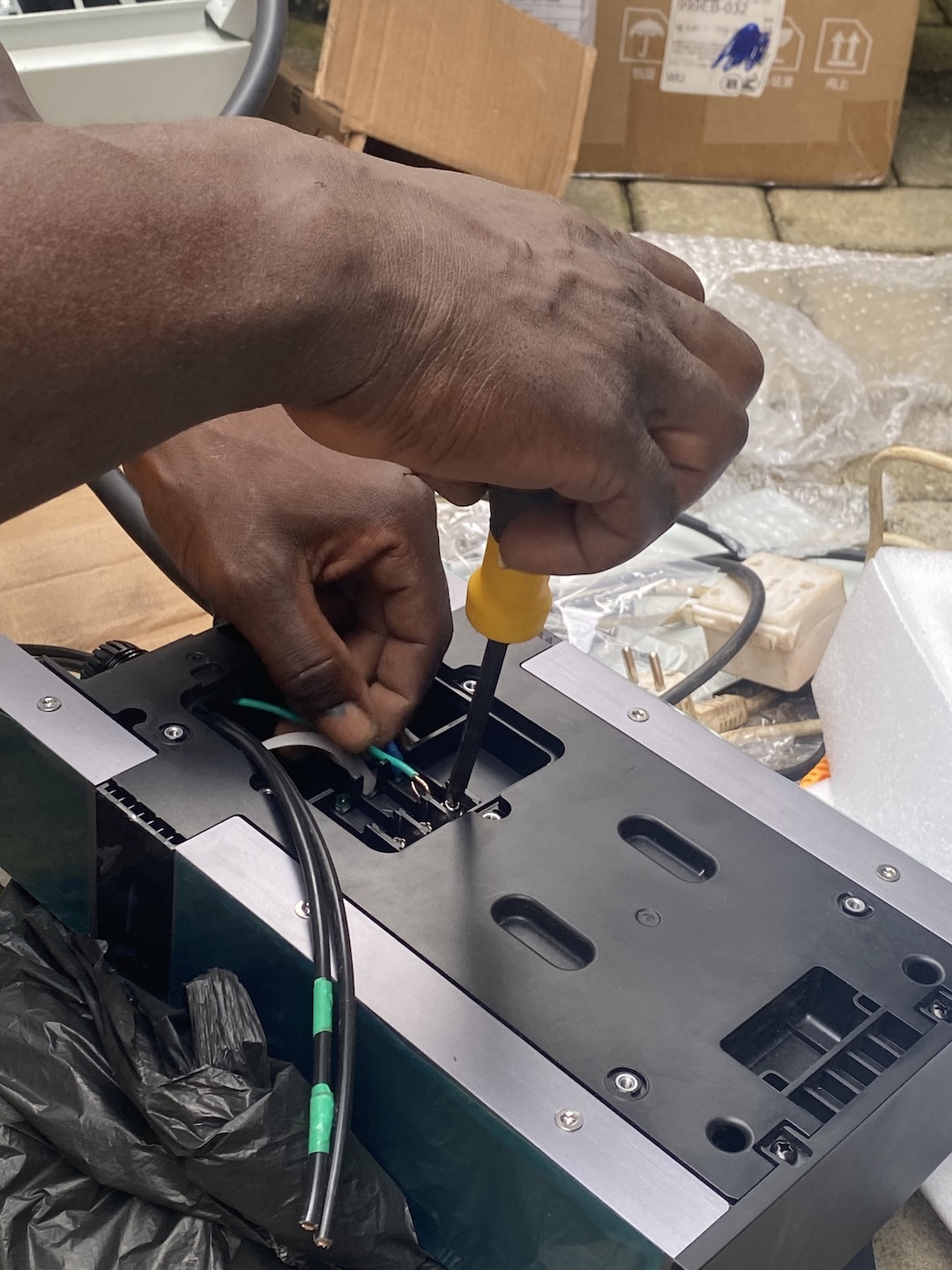 EV installers in Abuja wiring an EV charge point during installation