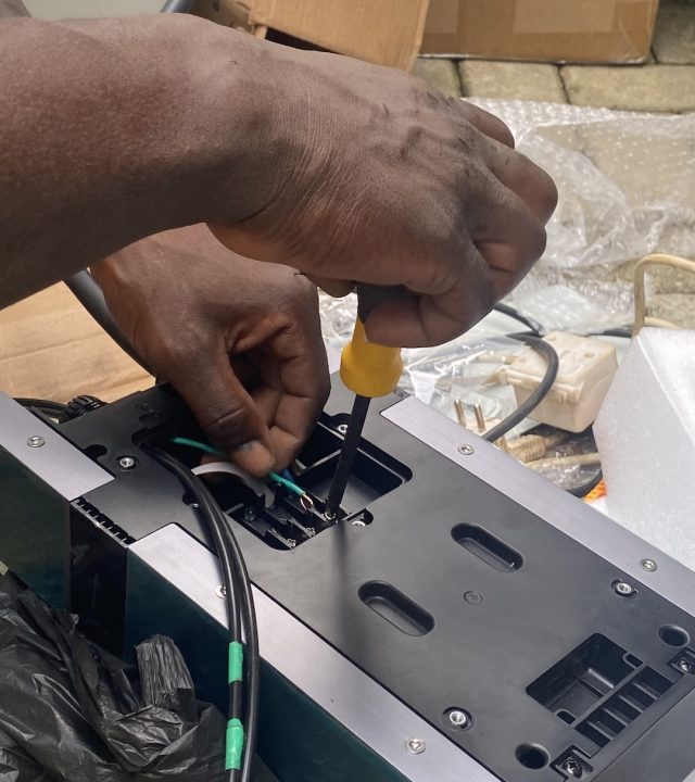 EV installers in Abuja wiring an EV charge point during installation
